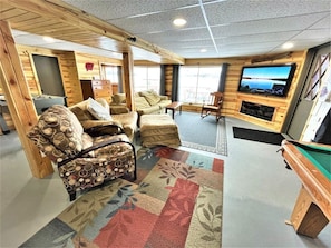 A cozy indoor space with a pool table, comfortable seating, and a television mounted on the wall. - Lakeview Retreat, Lakeside on the Flowage (Butternut)