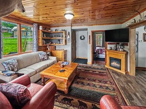 A cozy living room with a sofa, coffee table, and fireplace. - Lakeview Retreat, Lakeside on the Flowage (Butternut)