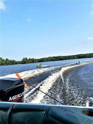 A water sport activity with a boat towing kayaks. - Lakeview Retreat, Lakeside on the Flowage (Butternut)