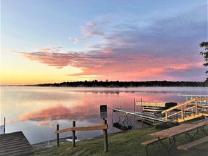 A calm lake at sunset with a dock and picnic tables. - Lakeview Retreat, Lakeside on the Flowage (Butternut)