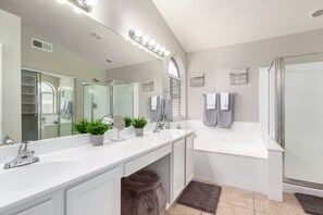 Bathtub, hair dryer, towels, toilet paper