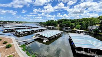 A marina with multiple docked boats and covered structures.
