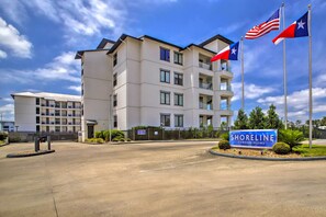 A modern multi-story building with a sign reading "Shoreline Condominiums." - Lakeside Montgomery Condo Near Boat Rental! (Montgomery)