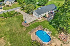 A residential property with a swimming pool, a covered patio, and a well-maintained lawn. - Peaceful Country Retreat w/ Easy Highway Access! (Browns Summit)