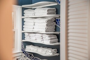 A bathroom with white shelves holding neatly folded towels. - Charming Fig Garden Village Spanish style home! (Fresno)