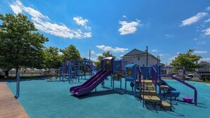 A playground with slides and climbing structures. - Downtown OC 2BR - Walk to Beach & Boardwalk! (Ocean City)