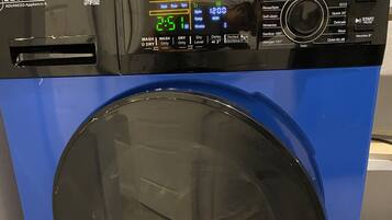 A blue and black washing machine with a digital display and multiple control buttons.