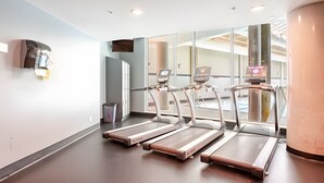 A fitness area with treadmills and a digital display.