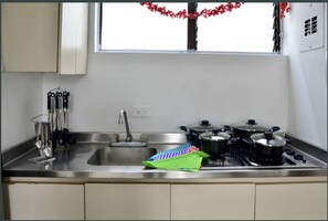 Microwave, cookware/dishes/utensils, dining tables