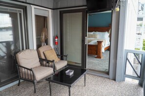 Un balcone con un divano, un tavolino e un estintore.