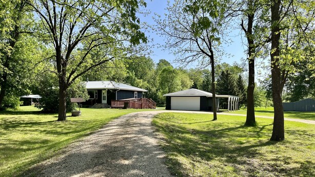 A gravel driveway leading to a house with a covered porch and a garage. - Countryside Home, Dog Friendly, Large Yard, Near Several Lakes (Alexandria)