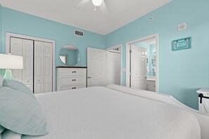 Cozy retreat with a large bed, white ceiling fan, and a stylish wardrobe.