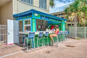 Enjoy refreshing drinks at the High Tides Poolside Tiki Bar, where you can sit and relax.