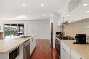 Enjoy cooking in this well-equipped kitchen with a dishwasher, stove, and coffee maker.