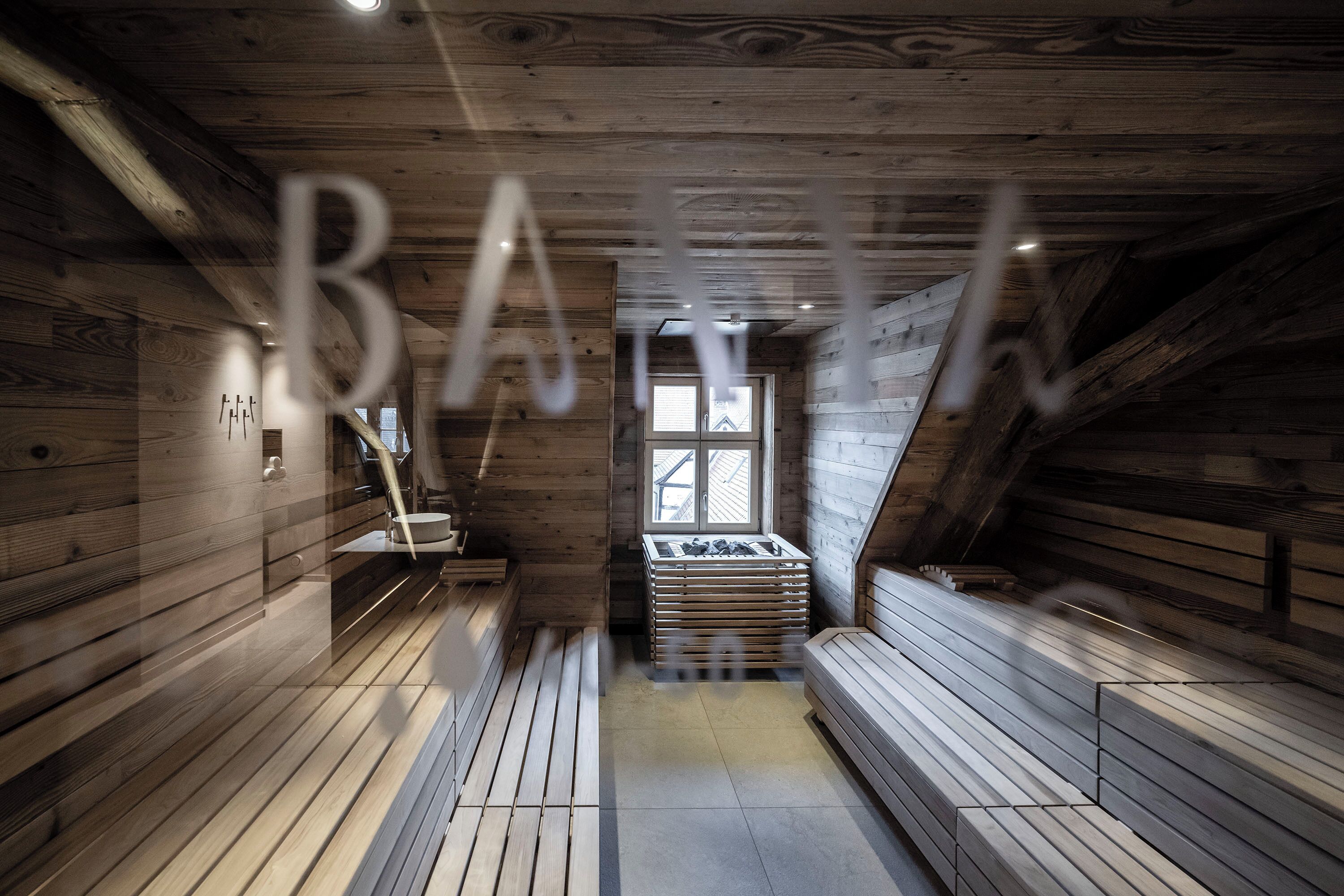 A sauna room with wooden benches and a bench stack.