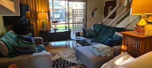 Relax in a welcoming space with a comfortable sofa, coffee table, and lamp.