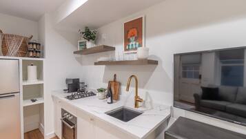 Fridge, microwave, coffee/tea maker, cookware/dishes/utensils