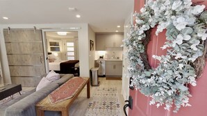 A modern living room with a sofa, a wooden coffee table, and a patterned rug. - Downtown DC Awaits with Parking Permit (Washington)