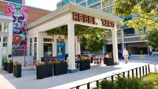 A building with a marquee sign reading 'REBEL TANGO' and a colorful mural on the side. - Downtown DC Awaits with Parking Permit (Washington)
