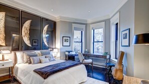 A bedroom with a large bed, a desk, a guitar, and a view of the outdoors. - Luxurious Mansion in Logan Circle Private Parking (Washington)