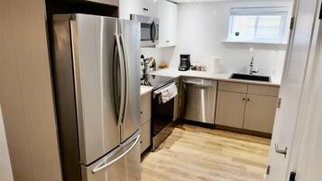 Fridge, microwave, coffee/tea maker, cookware/dishes/utensils