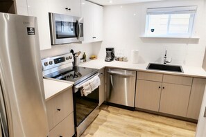 Fridge, microwave, coffee/tea maker, cookware/dishes/utensils