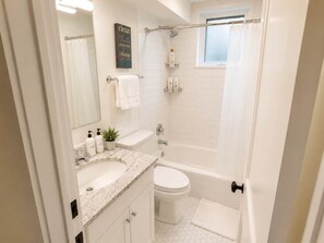Shower, hair dryer, towels, shampoo