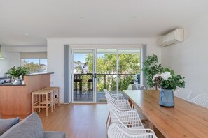 Enjoy a meal at the dining table, surrounded by lush greenery and a clear view.