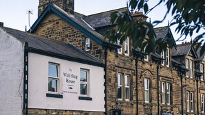 A traditional stone building with a sign for 'The Whitting House Hotel & Restaurant'. - The Whittling House (Alnwick)