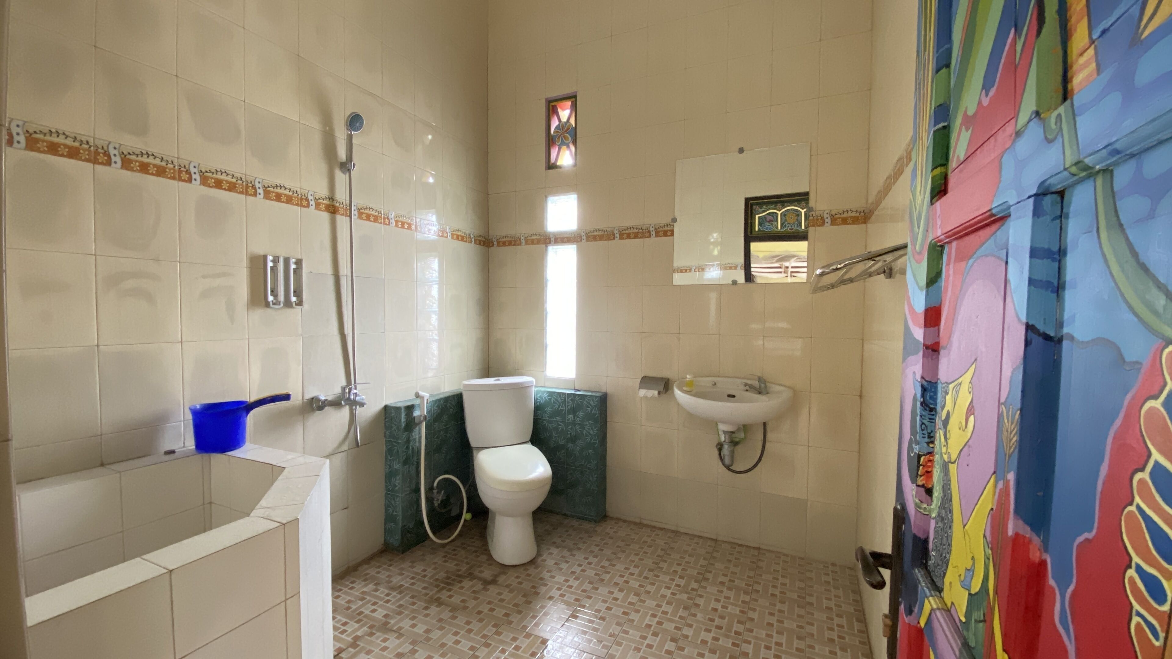 A bathroom with a bathtub, toilet, sink, and shower.