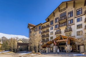 A multi-story hotel with balconies and a welcoming entrance.