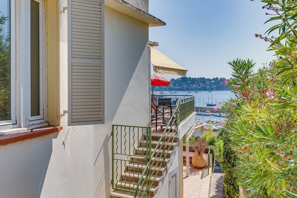 A balcony with a view of a marina and boats.