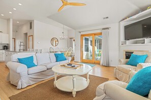 A modern living room with a sofa, coffee table, and TV.