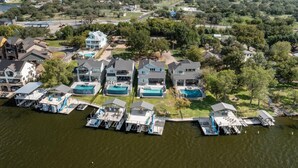 A residential area with houses, a dock, and a swimming pool. - Bud Bliss Retreat | Concierge Services (Kingsland)