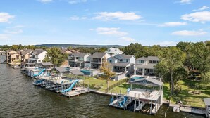 A waterfront property with multiple houses, a dock, and a swimming pool. - Bud Bliss Retreat | Concierge Services (Kingsland)