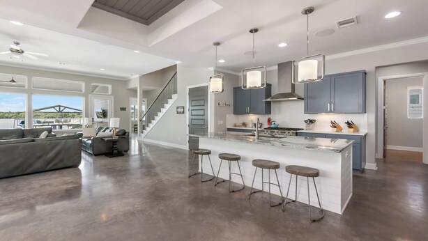 A modern kitchen with a central island, bar stools, and pendant lighting. - Bud Bliss Retreat | Concierge Services (Kingsland)