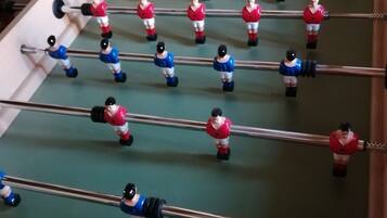 A foosball table with players in red and blue uniforms.