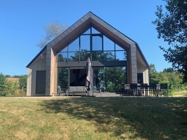 Enjoy outdoor dining and socializing in this charming pavilion with a covered patio area and comfortable seating.