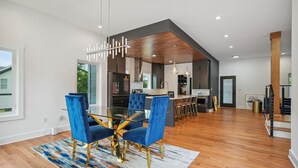 A modern kitchen with dark cabinetry, a central island, and pendant lighting. - New Modern 4BR Smart Home Downtown Atlanta GWCC (Atlanta)