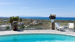 A pool with a clear view of the sea and distant landscape. - Villa Bella, Mikri Vigla.  Private pool, jacuzzi & amazing views. Sleeps 10+. (Naxos)
