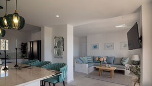 A modern kitchen with a central island, bar stools, and pendant lighting. - Villa Bella, Mikri Vigla.  Private pool, jacuzzi & amazing views. Sleeps 10+. (Naxos)