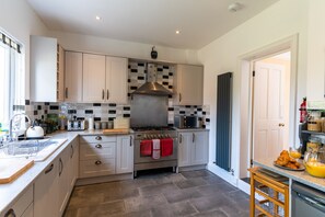 Enjoy cooking in this well-equipped kitchen with a central island, gas stove, and microwave.
