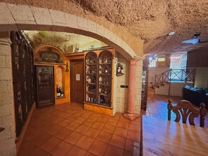 An interior with a tiled floor, a wine rack, and a staircase. - Duque Nest Hostel (Adeje)