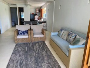 Relax in this stylish living area with a sofa, armchair, and rug, perfect for unwinding after a day out.