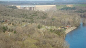 A dam with a water reservoir, a winding road, and a river. - 3A - Comfortable Wooded Setting (Branson)