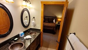 A bathroom with a sink, mirror, and towel rack. - 3A - Comfortable Wooded Setting (Branson)