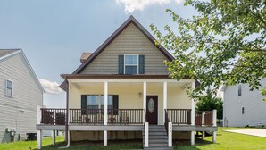 A two-story house with a front porch, a staircase leading to the entrance, and a number 137 on the front door. - The Haven, located in the heart of the Shenandoah Valley (Waynesboro)