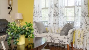 A living room with a sofa, a table with a plant, and a lamp. - The Haven, located in the heart of the Shenandoah Valley (Waynesboro)