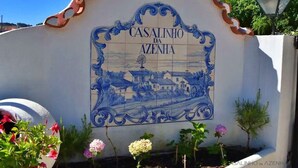 A sign with the text "CASALINHO DA AZENHA" and a blue and white decorative border.