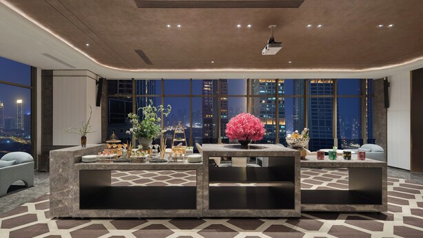 A modern hotel lobby with a large reception desk, seating area, and large windows offering a city view. - voco Chongqing Chaotianmen by IHG (Chongqing)